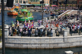 Bright boats and brightly dressed dancing humans. 