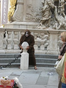 The Black death statue and busker