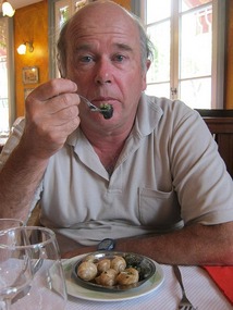 John eating escargots