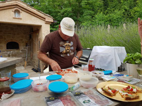 John preparing his pizza