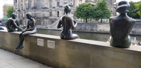 3 girls and a boy statue