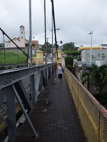 Carol walking across the New Bridge