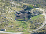 On a distant hillside, a sheep herder's farm