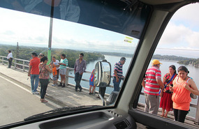 What are these people looking at from bridge top? 