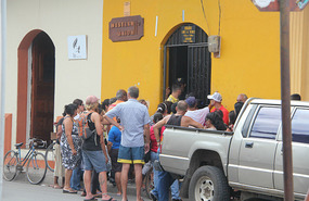 Outside the Western Union office waiting to open