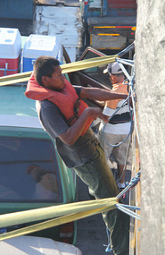 Crewmen unlashing vehicles