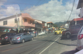 Boquete main street reflection in a car window
