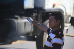 Trying to wave a bus down with money in hand