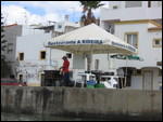 Barbying fresh sardines on the dock at Ferragudo