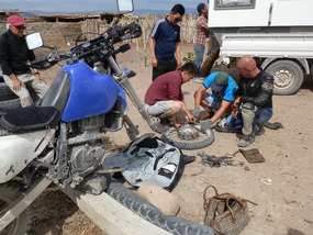 How many people are required to change a tire?
