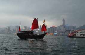 Barco chino con skyline de fondo