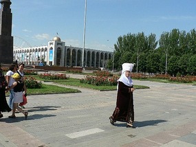 Woman in Traditional Kyrgyz Dress Near the Museum