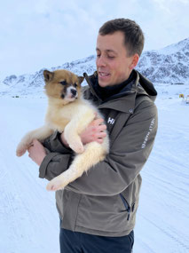 French Tourist Cuddles a Puppy