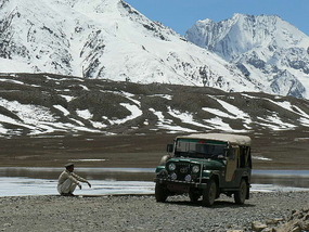 Zia Sits by his Jeep at Lake Shandur