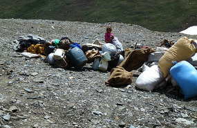 Yound Nomad Child With Family Belongings