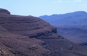 Our Road Winds Down the Bare Eroded Mountains