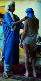 Young Woman Has her Shess Tied by One of the Staff