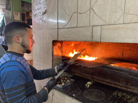 Grilling kababs at Kabab al Sha'ab