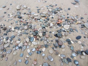 Multi-colored rocks on the lake shore.