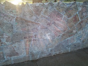 The wall on the street, filled with signatures