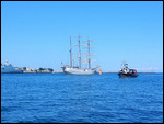 A late-leaving tall ship, seen from ferry