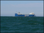 Ship with Orange Pilot Boat in Attendance