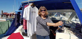 Julie on winch duty as we hoist the sails