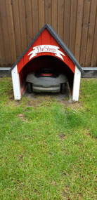Cute robot lawn mower shed