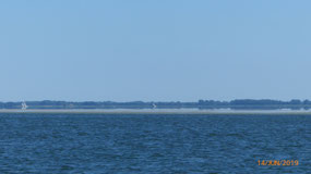 Note silvery, calm water beyond sand bar