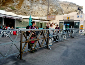 Kara waiting for ferry - Santorini harbor - Greece