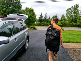 Kara bringing her backpack to car
