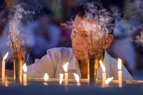 Pilgrim lighting candles