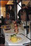 Bacon wrapped fish hanging on a skewer