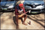 Painting a giraffe he had carved from Jacaranda