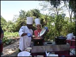 Pouring coconut cream into the tomato sauce