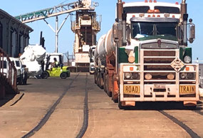 Fork Lift shifting bags behind fuel truck