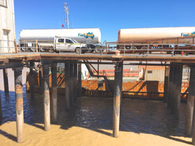Tide out boat taking on fuel load for Koolan