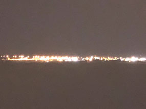 BHP lit up at night over the tidal flat
