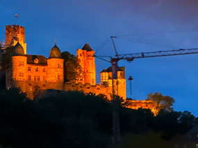 Castle along Main River at night