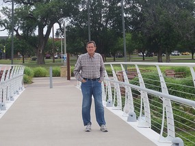 John on the bridge near Keeper of the Plains