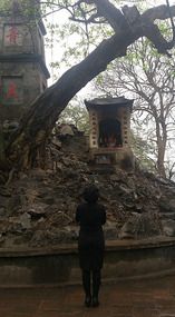 Woman praying at a shrine