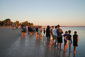 People on beach awaiting the Dolphin's arriva