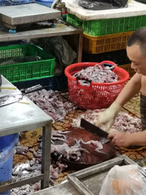 Preparing frogs in the market