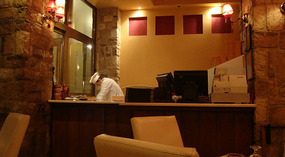 The cook preparing a pizza