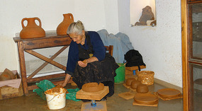 Mrs. Theognosia creating a clay pot 