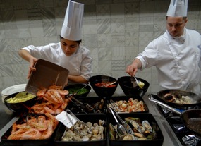 Seafood preparation by the open kitchen of Oceana