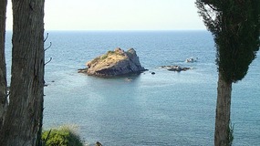 The imposing rock and fishing boat