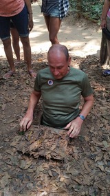 Alan squeezing into Chu Chi tunnel