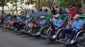 Cyclo drivers waiting for their next busload 