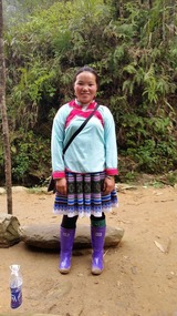 Flower Hmong Guide,note the beaded skirt she made